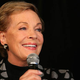 Julie Andrews holding a microphone.